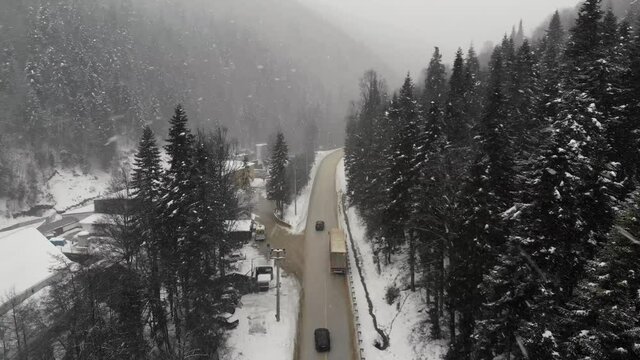 Snowy weather in mountains. Flying over carriageway in Bolu Region. Drone footage in winter time  