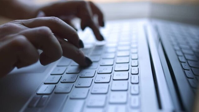 Working Remotely. Stay At Home. Close up of fingers typingon laptop. Young Woman working from home in internet in self-isolation, quarantine