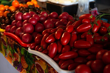 Beautiful red  tomatoes on the counter in the market in daylight organic food