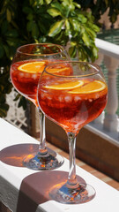 Aperol spritz in big glasses red summer cocktail, terrace party. High quality photo