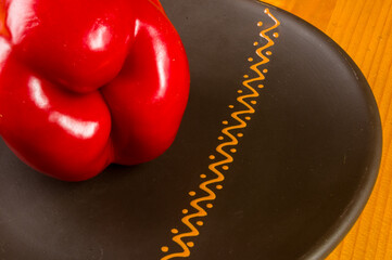 a freshest red paprika, bell pepper in ceramic plate