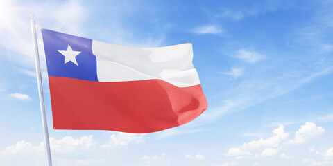 Fototapeta na wymiar Chile flag on a flagpole waving in blue cloudy sky. Chile concept 3D rendering