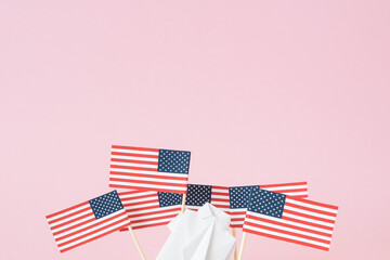 Man waving American flag. Figure of human holding usa banner. Many flags from toothpicks around. Concept social movement, demonstration against the discrimination of society. Rights and tolerance.