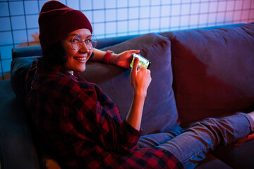 Virtual reality woman gamer in mobile phone, addicted teen. Girl having fun playing online mobile game on her smart phone. © romankosolapov