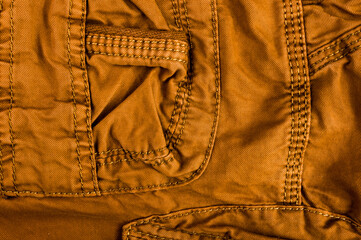 clothing items stonewashed cotton fabric texture with seams, clasps, buttons and rivets, macro