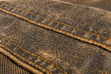 clothing items stonewashed cotton fabric texture with seams, clasps, buttons and rivets, macro