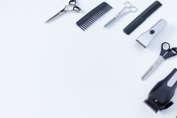 Composition with scissors and other hairdresser's accessories on white background, top view