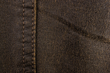clothing items stonewashed cotton fabric texture with seams, clasps, buttons and rivets, macro