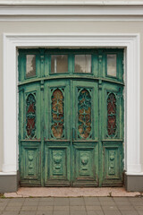 Old green wooden front door. Classic retro doors in city