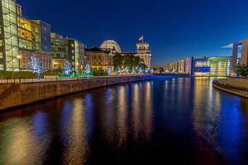 View on illuminated Reichstag building in Berlin during evening twillight in summer
