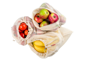 top view of tomatoes, banana and apples in eco friendly mesh bags isolated, zero waste concept
