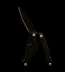 multifunctional multitool knife on a black background.