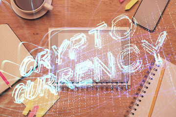 Double exposure of blockchain theme hologram over table with phone. Top view. Crypto technology concept.