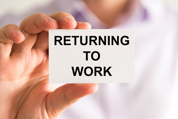 Businessman holding Returning To Work message card
