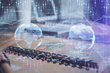 Double exposure of financial graph drawings and desk with open notebook background. Concept of forex market