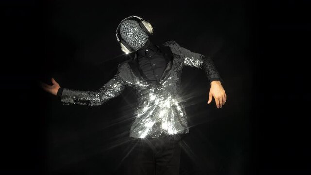 Mr disco ball wearing silver jacket dancing