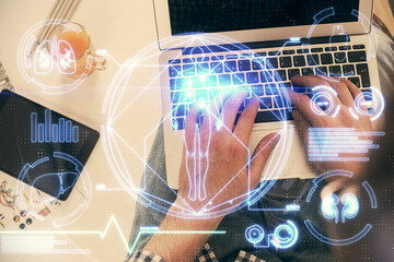 Double exposure of man's hands typing over computer keyboard and science theme hologram drawing. Top view. Education concept.