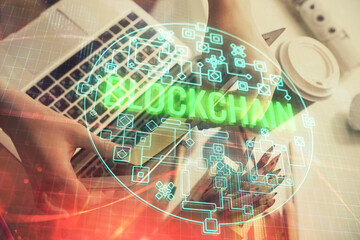 Double exposure of woman hands typing on computer and crypto market theme hologram drawing. Blockchain concept.
