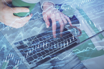 Double exposure of woman hands typing on computer and forex chart hologram drawing. Stock market invest concept.