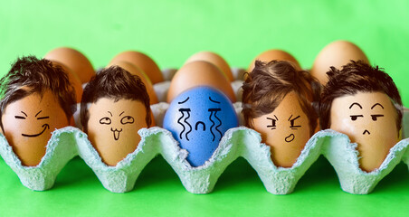 The odd one, Faces on the eggs, no to racism concept