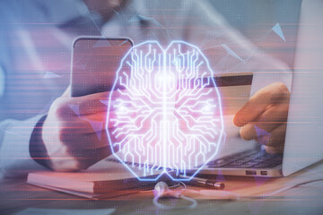 Double exposure of man hands typing on computer with credit card and brain theme drawing....
