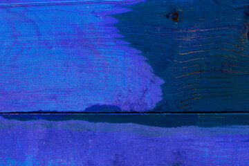 The blurred texture of a wood painted in blue color. The photo was shot close-up for your unusual design.