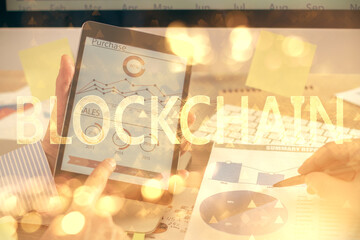 Double exposure of man's hands holding and using a phone and crypto currency blockchain theme...