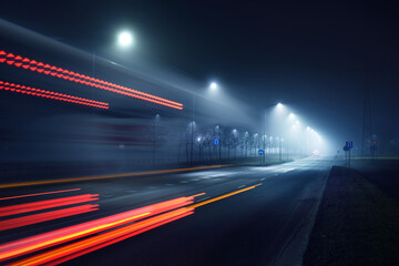 An empty highway in a fog at night. Street Lights close-up, motion blur effect, long exposure. Dark...