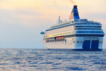 Large white cruise liner (passenger ship) sailing in the Baltic sea at sunset. Finland, Aland. A...