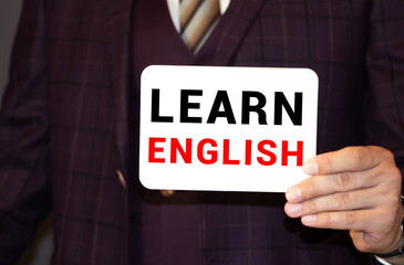 Fototapeta premium Businessman hand touching LEARN ENGLISH tab on virtual screen , business concept , business idea