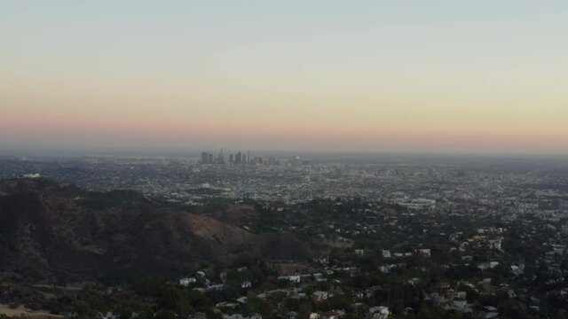 AERIAL: View over Los Angeles in Hollywood Hills at Sunset, Los Angeles, California 