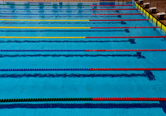 Blue Water of swimming pool with empty lanes.