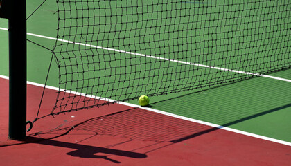 Closeup of Tennis Racket and balls on Tennis Courts in the outdoors.