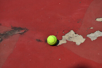Closeup of Tennis Racket and balls on Tennis Courts in the outdoors.