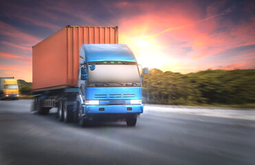 Container truck on the highway at sunset sky background.