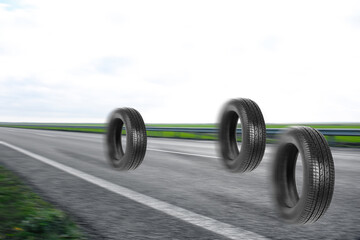 Obraz na płótnie Canvas Car tires rolling on asphalt highway outdoors