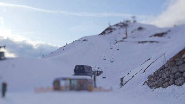 View of chairlift on top of Nordkette mountain with moving clouds in background