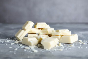 Delicious white chocolate on light grey table