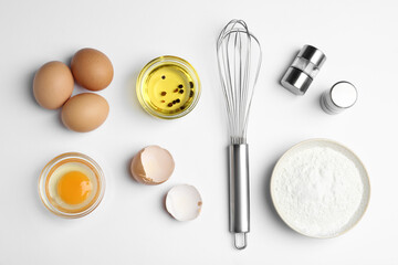 Flat lay composition with chicken eggs on white background