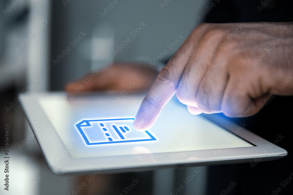 Poster man clicking on document icon using tablet, closeup