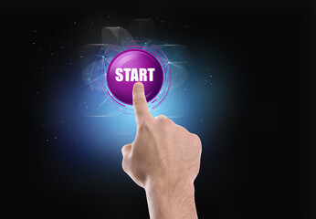 Man pointing at start icon on dark background, closeup