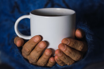 woman holding a cup of hot coffee