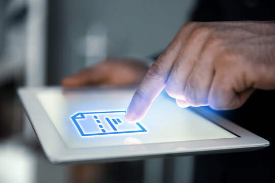 Man clicking on document icon using tablet, closeup