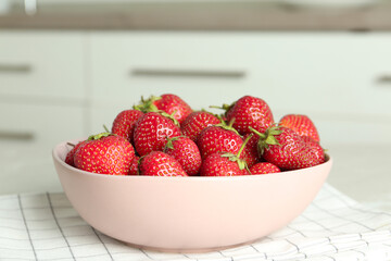 Delicious ripe strawberries in bowl on table indoors