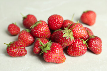 Delicious ripe strawberries on light grey table, closeup