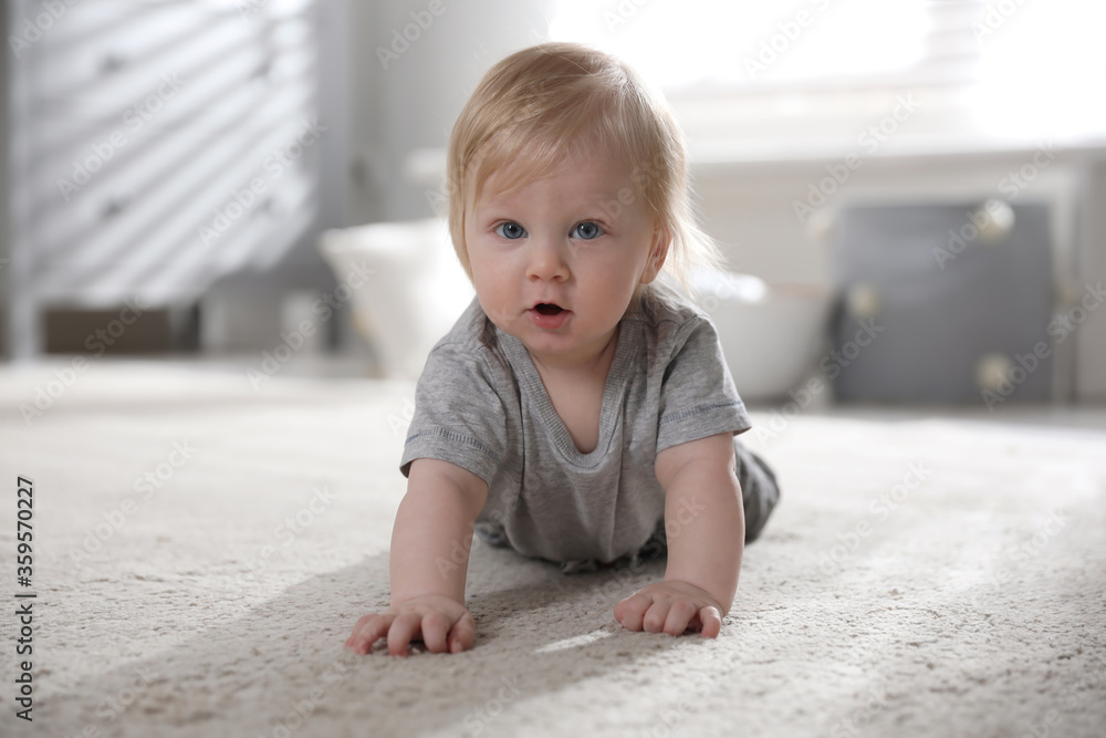 Wall mural Adorable little baby on floor at home