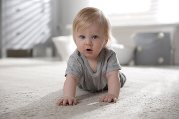Adorable little baby on floor at home