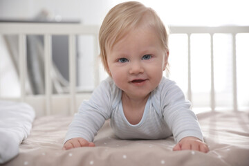 Fototapeta premium Adorable little baby lying in comfortable crib