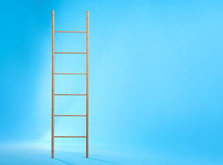 Modern wooden ladder on light blue background. Space for text