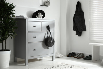 Grey chest of drawers in stylish room. Interior design